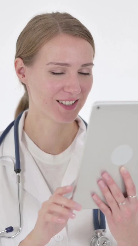 Video Call on Tablet by Female Doctor on White Background, Vertical Video Vídeos de archivo 340040053