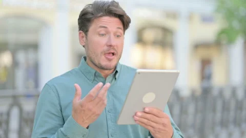 Video Call on Tablet by Middle Aged Man Outdoor Video stock 157513796