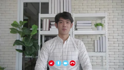 Video calling concept of 4k Resolution. Young Asian businessman giving an int Stock Footage 145287174