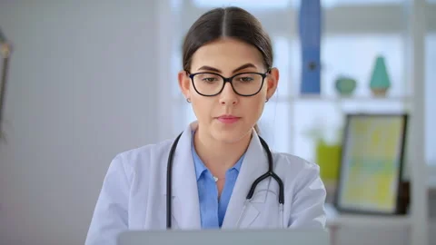Video Calling Distant Patient on Laptop. Doctor Talking to Client in Home Office Stock Footage 143160136