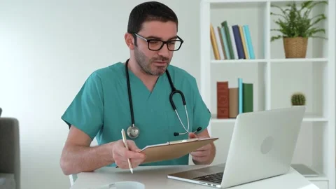 Video calling distant patient on laptop Video stock 185046549
