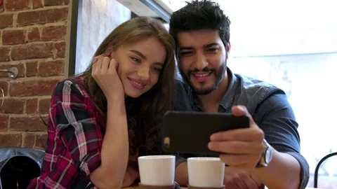 Video Calling. Happy Couple Using Phone For Video Call In Cafe Stock Footage
