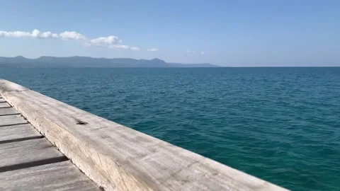 Video of calming waves during a warm sunny morning with a blue cloudless sky. vi Stock Footage 220766660