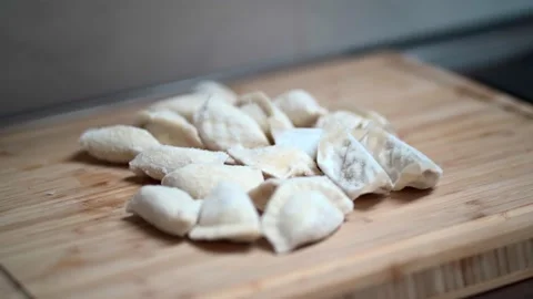 Video of a camera approaching to a bunch of frozen gyoza dumplings on wooden 스톡 동영상 146875111