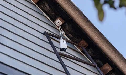 Video camera for home security, camera installation Stock Photos