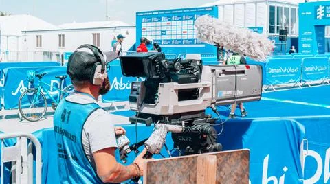 Video camera operator - man filming on set with his equipment - TV production Stock Photos