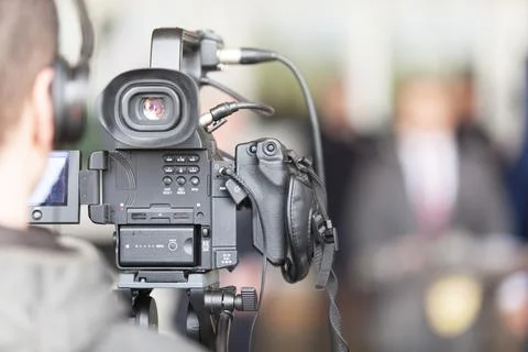 Video camera operator working at news conference Stock Photos