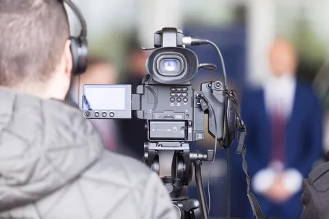 Video camera operator working at press conference Stock Photos