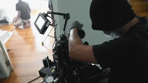 Video camera on professional tripod Stock Photos