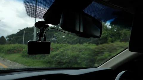 Video camera recorder on front windshield with car driving on road Stock Footage 94176802