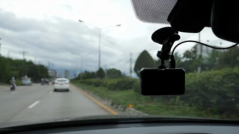 Video camera recorder on front windshield with car driving on highway road Stock Footage 94176974