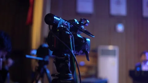Video Camera on tripod recording event Stock Footage 230982789