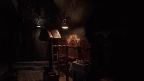 A video capturing devotion with dim lighting inside the small church of the Stock-Footage 301891695