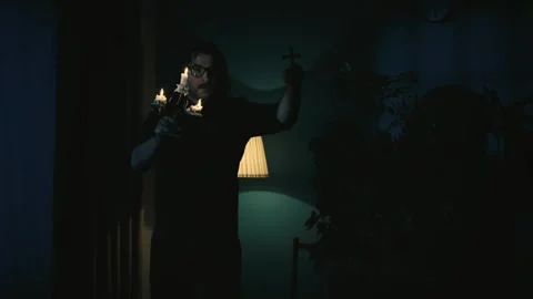 Video capturing a priest walking around the room holding a candlestick and a Video stock 249521425