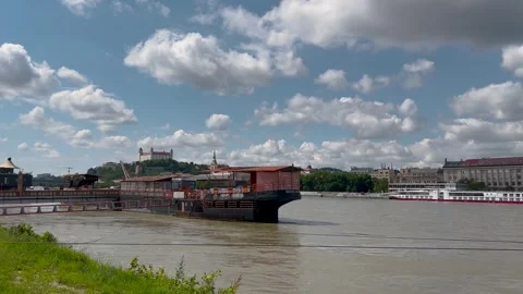 A video capturing a riverside scene with a docked floating restaurant Video stock 298610666