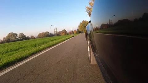 Video of a car driving camera mounted outside a black car viewpoint low pov Stock Footage 257010120