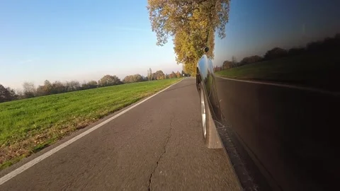 Video of a car driving camera mounted outside a black car viewpoint low pov Stock Footage 257010130