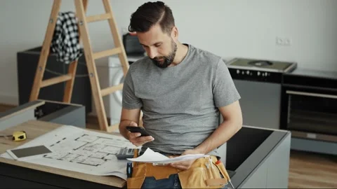 Video of carpenter scrolling through the phone Stock Footage 134607702