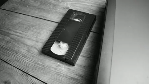 Video cassette is on the table next to the VCR Stock Footage 138143867
