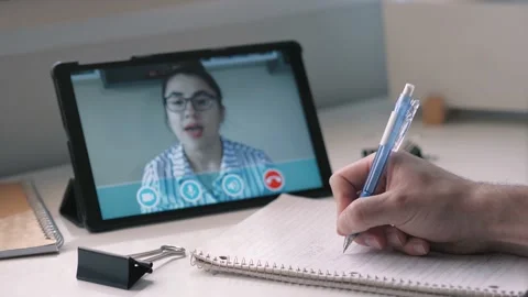 Video Chat Call on a Tablet Taking Notes at a Desk Stock Footage 132042831