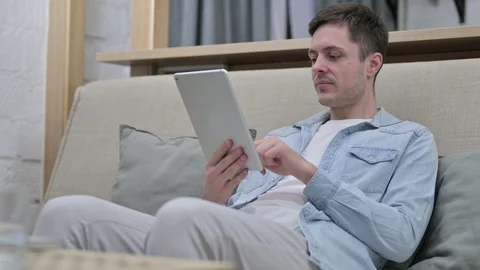 Video Chat on Tablet by Young Man at Home Video stock 123630692