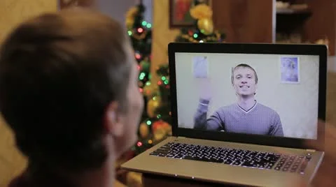 The video chatting with young man on the screen of modern notebook Stock Footage 18915588