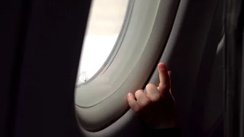 Video of child looking through the airplane window in real slow motion Stock Footage 77414533