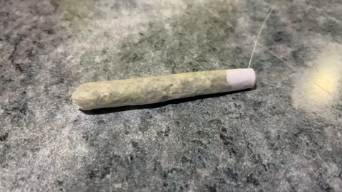 Video of cigar made of marijuana on a table. Drug concept. Stock Footage 252711857