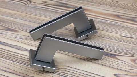 Video with circular rotation of door handles on a wooden background. 360 Stock Footage 292377187