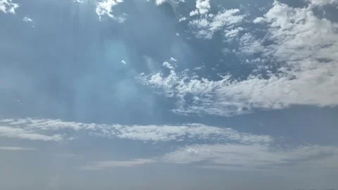 Video of a clear blue sky with moving clouds and flares in real time Stock Footage 259657781