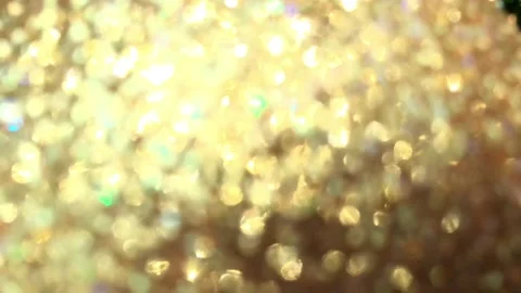 Video clip of defocus blurred close-up gold glitter ball in full-frame Stock Footage 120500976