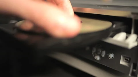 Video clip of a hand putting a DVD disk into a DVD ROM Stock Footage 233452798