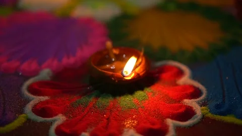 Video clip of lightened earthen Diya placed over colorful rangoli Video stock 255482149