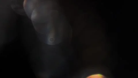 Video clip of motion of prismatic texture of bokeh light on black background 動画素材 317455402