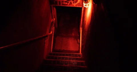 Video clip moving down dark stairs to open door 스톡 동영상 88644075
