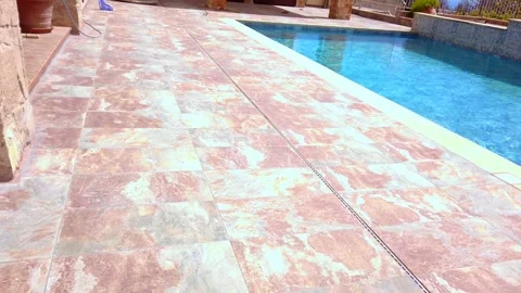 Video clip of pool and ground tiles after the fire repairs the the house and Stock Footage 333890090
