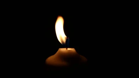 Video clip shows a close up view of a white candle in the darkness Stock Footage 160672605