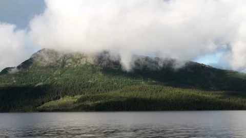 Video clip shows the water surface of a fjord with a mountain in the background Stock Footage 160830397