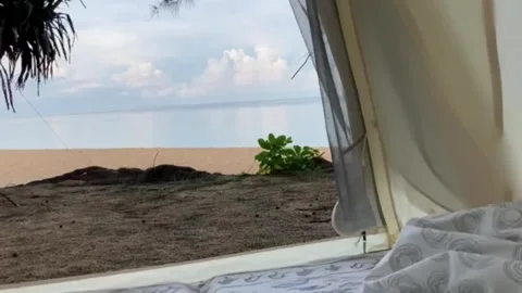 The video clip of view from an inside tent near the blue beach Stock Footage 196979121