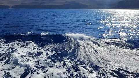 Video close up of a deep blue water waves moving behind fast moving ferry Stock Footage 308412921