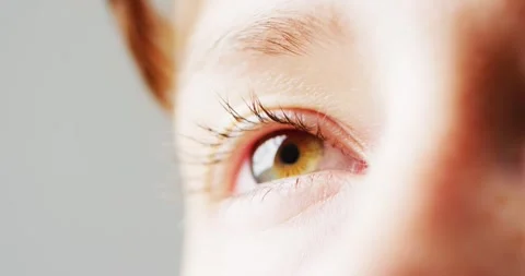 Video close up detail of the blinking green eye of a caucasian woman, with copy Stock Footage 331245940