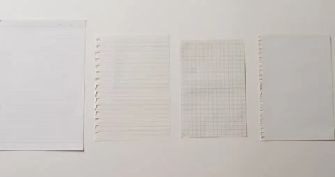Video of close up of four sheets of notebook paper on white background Stock Footage 331294933