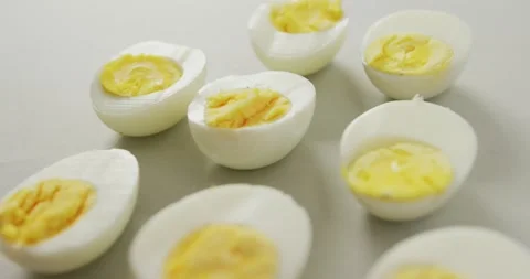 Video of close up of halves of hard boiled eggs on grey background Stock Footage 341664313
