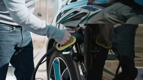 Video of close up of man charging electro car at the electric gas station Stock Footage 243176755
