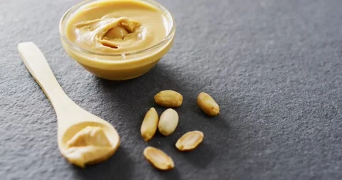 Video of close up of peanut butter on gray background Stock Footage 209597735