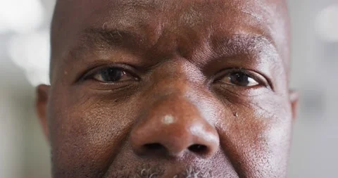 Video close up portrait of the opening, blinking eyes senior african american Stock Footage 236036234