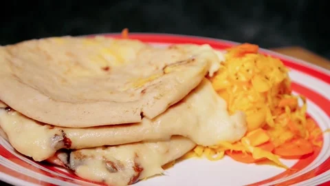 Video close up push in of cheese pupusas from El Salvador, nestled on a vib.. Video stock 266462371