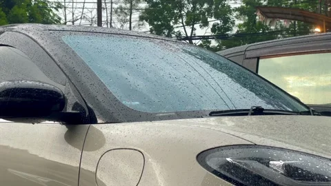 Video close-up rain drops on car windshield and hood Stock Footage 322592433