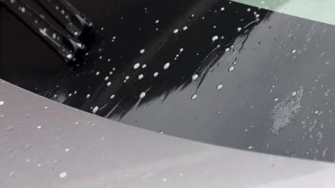 Video close up of soap from washer fluid coming down on windshield. Stock Footage 341681735