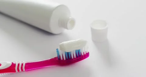 Video of close up of toothbrush and paste on white background Stock Footage 331207832